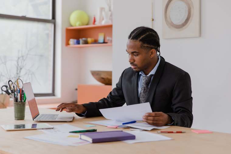 An entrepreneur works on accounting and administrative documents to manage their micro BIC status.