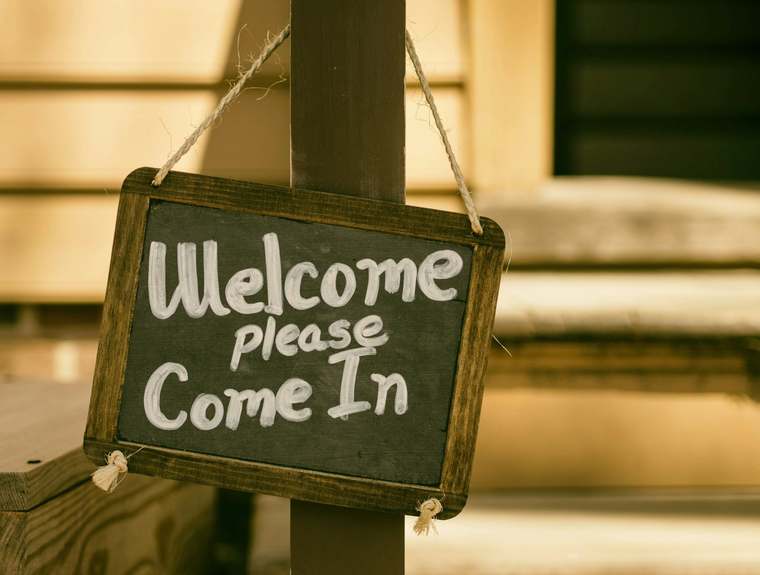 A host explains the house rules to a guest upon arrival at the rental property.