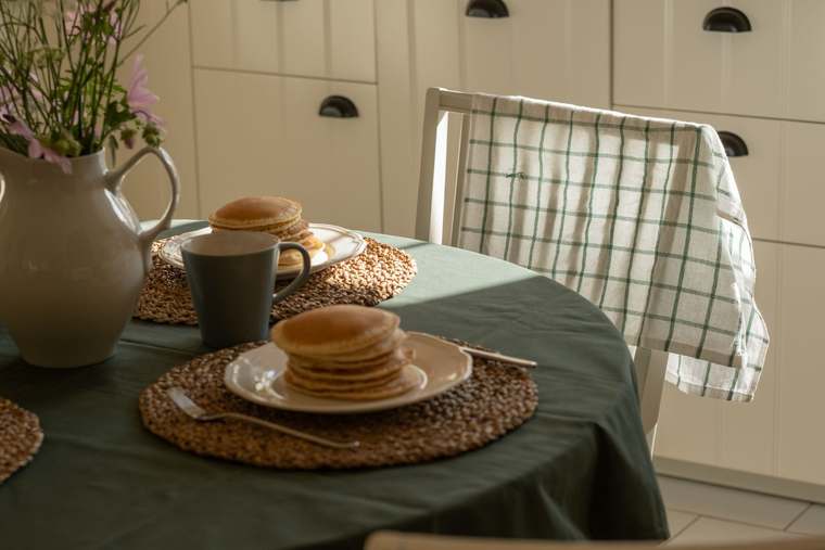 A breakfast table laid with local products and pastries set out to welcome travellers.