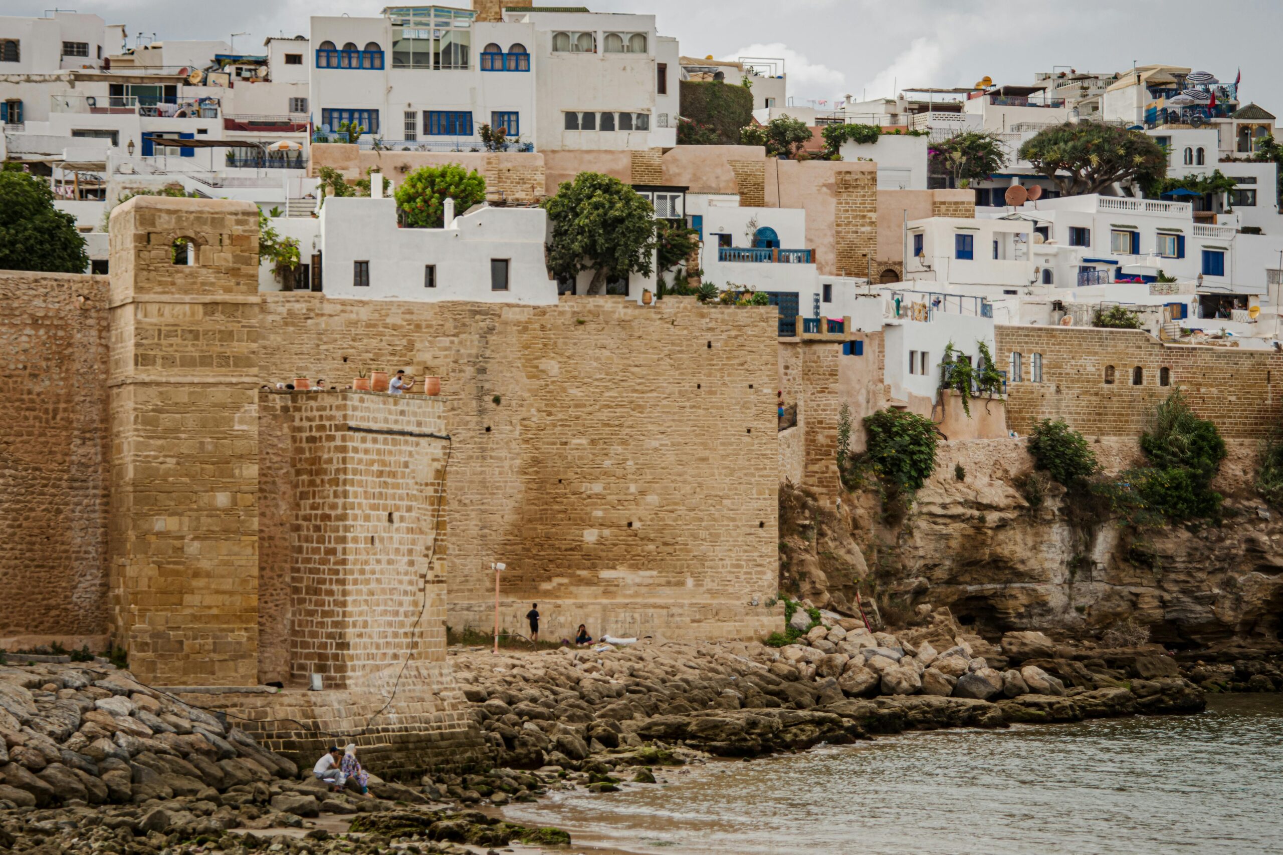 Remparts en pierre de la kasbah des Oudayas &agrave; Rabat avec maisons blanches et c&ocirc;te rocheuse